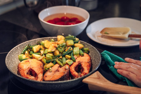 Grilled trout steak. Stir frying. The zucchini and green beans are pan fried. Electric hobの写真素材