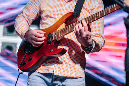Artist playing electric guitar on the stageの写真素材