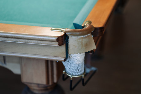 Billiard table with green surface and balls in the billiard club.