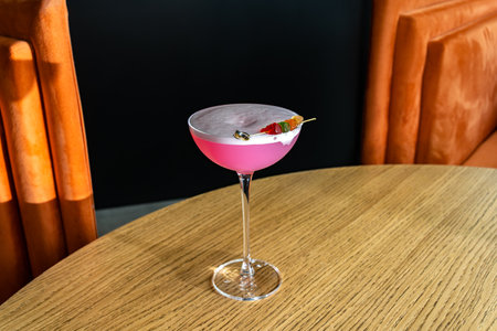 Shiny cocktail glass with fresh pink alcohol drink and jelly bears. Beverage and drinks backgroundsの写真素材