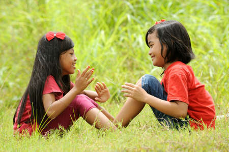 Girls playing in a field の写真素材