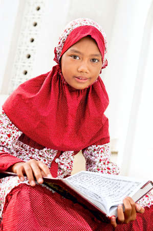 Child holding Koran