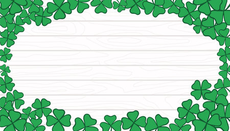 St. Patrick s Day Frame with copy space. Green leaves on white wooden texture backdrop. Shamrock and clover template, banner, backgroundのイラスト素材