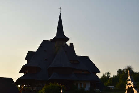 Barsana Orthodox Abbess, a multi-storey building in the Maramures style of wooden churches, with multiple roofs, beautifully decorated, in traditional style, intended for monastic ruleの写真素材