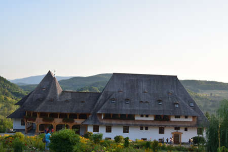 Barsana Orthodox Abbess, a multi-storey building in the Maramures style of wooden churches, with multiple roofs, beautifully decorated, in traditional style, intended for monastic ruleの写真素材