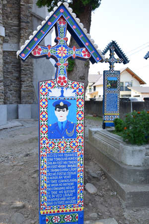 Cross from the Merry Cemetery in Sapanta Maramures the only place in the world where people laugh at death.Each cross is painted in vivid colors and tells a happy story from the life of the deceasedのeditorial素材