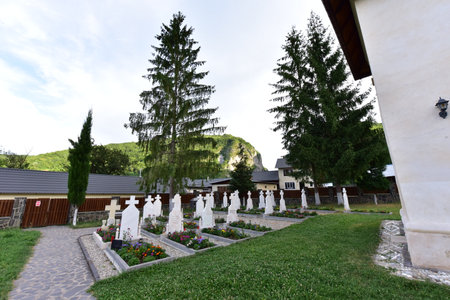 The small cemetery of Polovragi Monastery located next to the church of the sick of the monastery, sleeps its eternal sleep in the shade of fir trees, monks and nuns who served the monasteryの写真素材