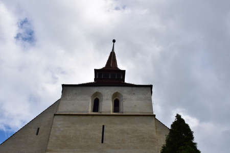 The Catholic church in citadel of Sighisoara built in an eclectic style inspired by Italian architecture with decorative arches,Roman rosettes,bell tower and exterior plaster with embossed rectanglesの写真素材