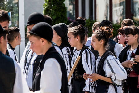girl from Novaci Romania dressed in a national shepherd's costume made of linen fabric with traditional black motifs and wearing a black scarf with tassels on her headのeditorial素材