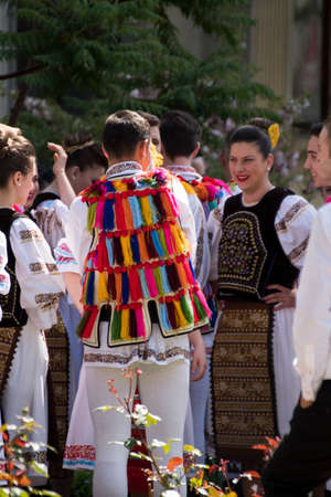 Folk dancers from Transylvania wear astrakhan lambskin hats adorned with peacock beads and feathers,...
