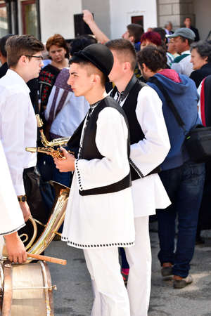 Folk artists performing folk music at Novaci Romania in national pastoral costumes made of linen...