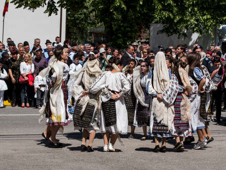 Folk dancers in Gorjian national costumes composed of traditional hand-embroidered ie skirt or skirt,valnec, and bat. the material used to make this traditional folk costume is white canvas and cottonのeditorial素材
