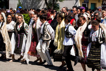 Folk dancers in Gorjian national costumes composed of traditional hand-embroidered ie skirt or...