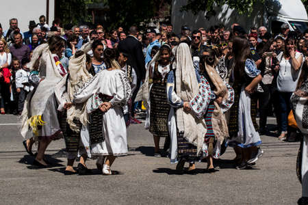 Folk dancers in Gorjian national costumes composed of traditional hand-embroidered ie skirt or skirt,valnec, and bat. the material used to make this traditional folk costume is white canvas and cottonのeditorial素材