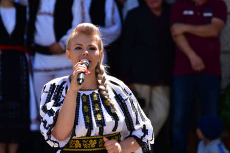 Folk artists performing folk music at Novaci Romania in national pastoral costumes made of linen...