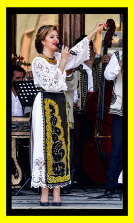 Folk artists performing folk music at Novaci Romania in national pastoral costumes made of linen...