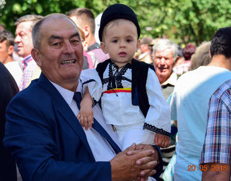 boy from Novaci Romania dressed in national linen shepherd costume, sewn with traditional black motifs and wearing a black cloth hatのeditorial素材