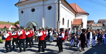 Hermannstadt marching band consisting of wind and percussion musicians dressed in uniforms consisting of black pants, red jacket, and white shirtsのeditorial素材