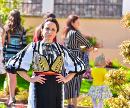 Girls from Poiana Sibiului Romania dressed in national shepherd`s costume made of sewn linen with...