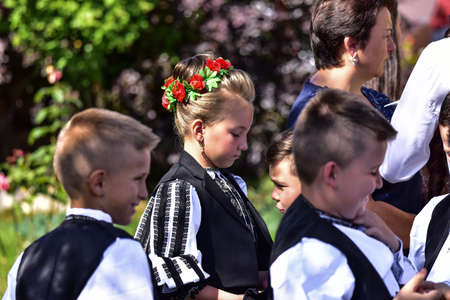 Girls from Poiana Sibiului Romania dressed in national shepherd`s costume made of sewn linen with traditional black motifsのeditorial素材