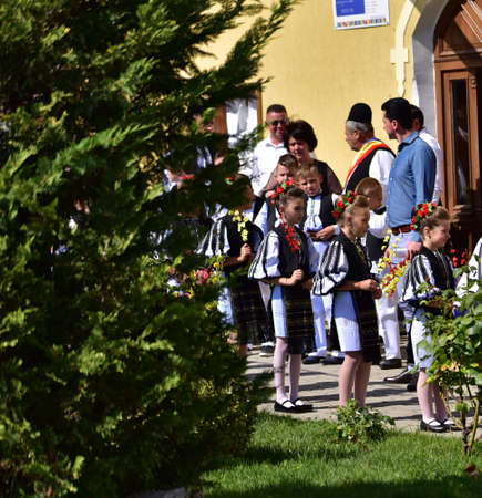 Girls from Poiana Sibiului Romania dressed in national shepherd`s costume made of sewn linen with traditional black motifsのeditorial素材