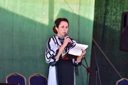 Girls from Poiana Sibiului Romania dressed in national shepherd`s costume made of sewn linen with traditional black motifsのeditorial素材