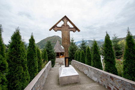 Wooden cross at the entrance to the temple on the background of the mountainsの写真素材