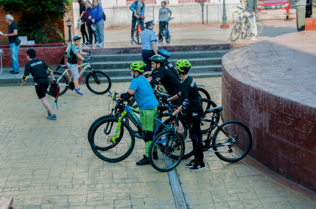 View of unknown bikers rolling through the streets of Kathmandu in the afternoonの写真素材