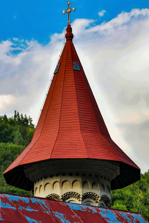 Fragment of the roof of the church against the sky with cloudsの写真素材