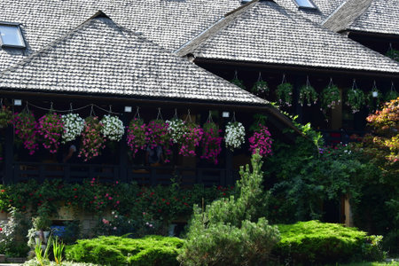 Wooden house with flowers on the terrace of the house.の写真素材