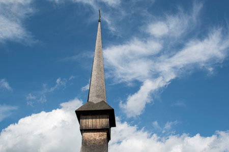 Detail of a church steeple against a blue sky with cloudsの写真素材