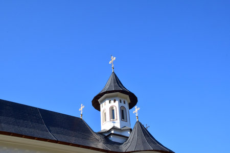 church roof against blue sky, closeup of photo with selective focus