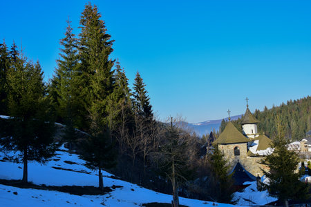 Winter landscape with church in the mountains. Carpathians, Ukraine