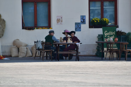 A man and a woman sit at a table in a cafe.の写真素材