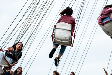 Unidentified people on a swing at the Bucharest amusement parkの写真素材