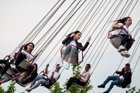 People having fun on a swing at Expo, universal exposition on the theme of food in Milan