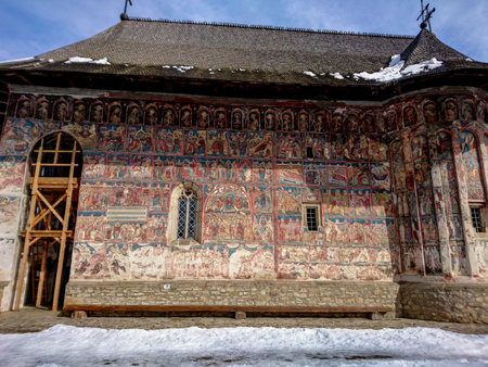 Ancient roman frescoes on the facade of the Church of St. John the Baptist in VoroneÈ Romaniaの写真素材
