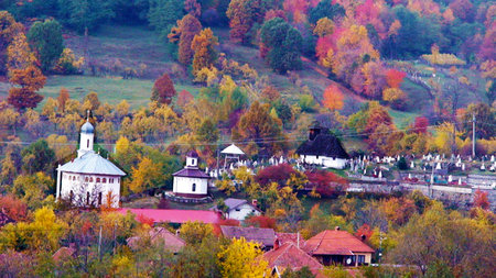 Autumn landscape with church and village in the mountains, Romania.の写真素材