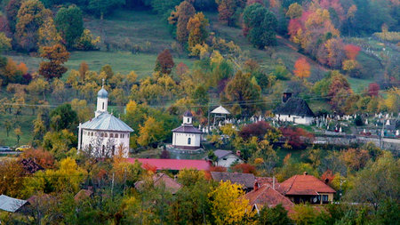 Autumn view of the village and church in Transylvania, Romaniaの写真素材