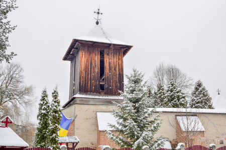 Old wooden church in the village in winter. Cotmeana VÃ¢lcea Romaniaの写真素材