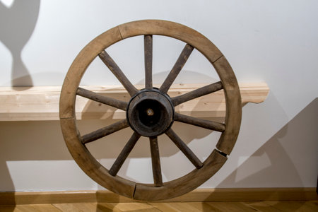 wooden wheel of a wagon on a wooden shelf in a museumの写真素材