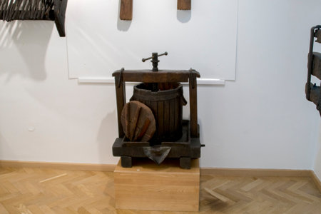 Old wine press on a white wall in the interior of the houseの写真素材