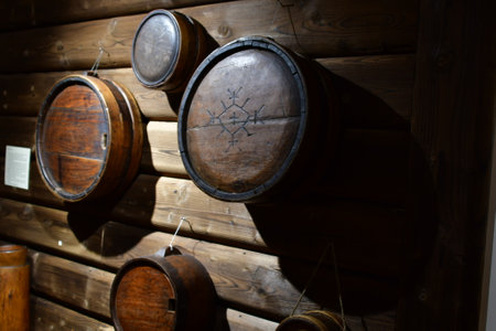 Wooden barrels on the wall of a country house in Poland.の写真素材