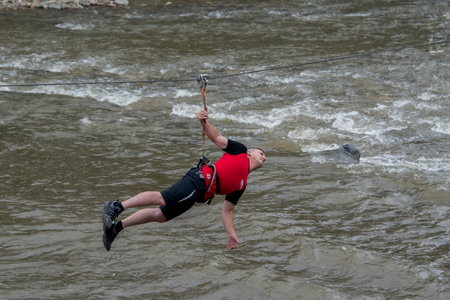 A man jumps over the river.