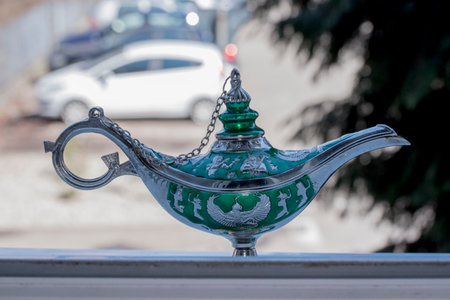 Aladdin magic lamp on the background of the street.