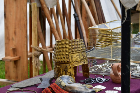 Medieval weapons and objects on display in a flea market.