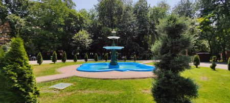Panoramic view of the fountain in the park. Sunny summer day.の写真素材