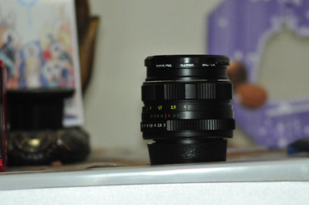 Camera lens on a white background. Close-up, selective focus.
