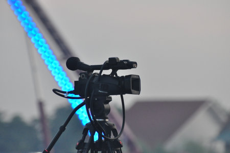 cameraman with blue led light at the concert in the eveningの写真素材