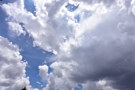 The vast blue sky and clouds form a beautiful background.
